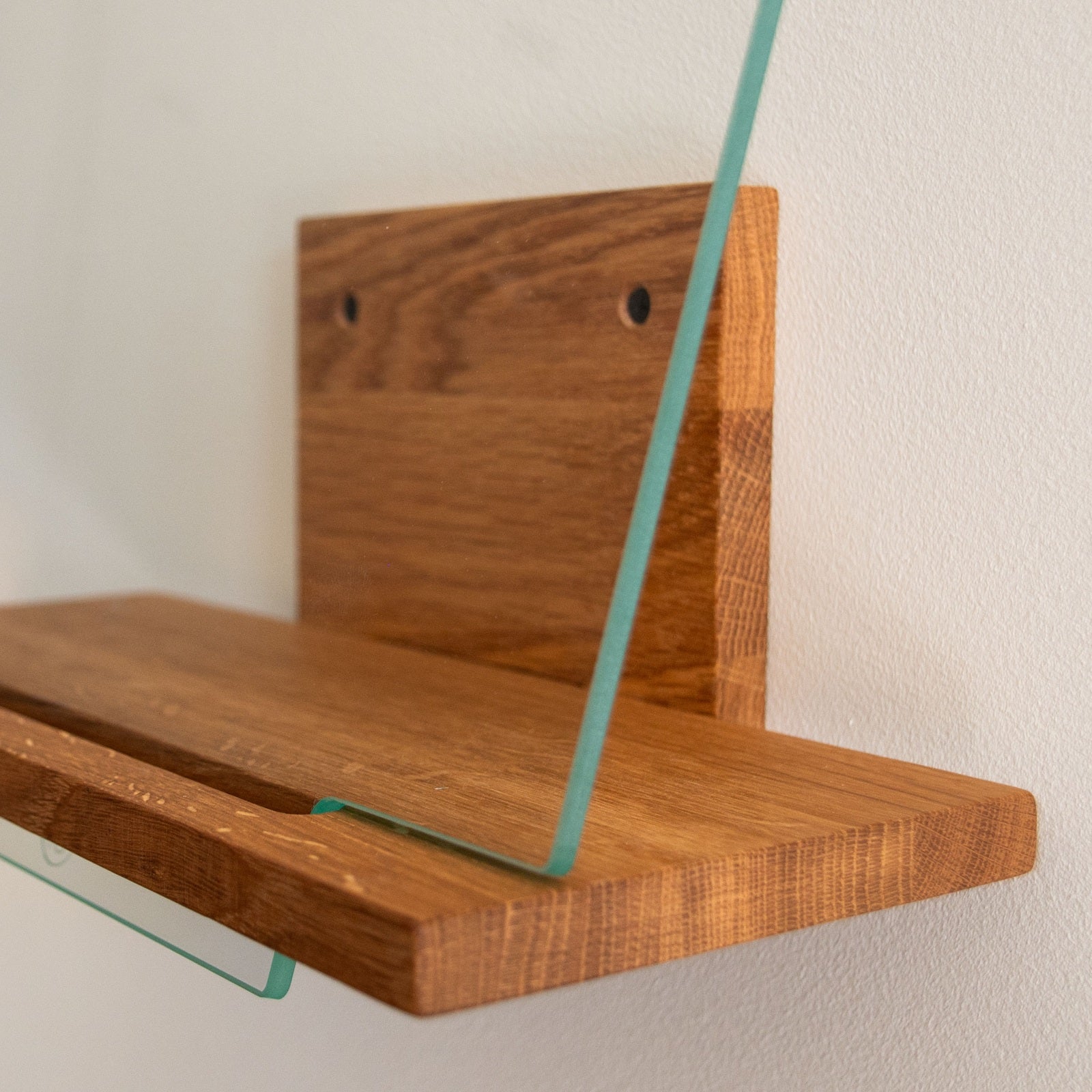 Detail van het massief eikenhout en geharde glas van het Display MULTI platenrek voor aan de muur